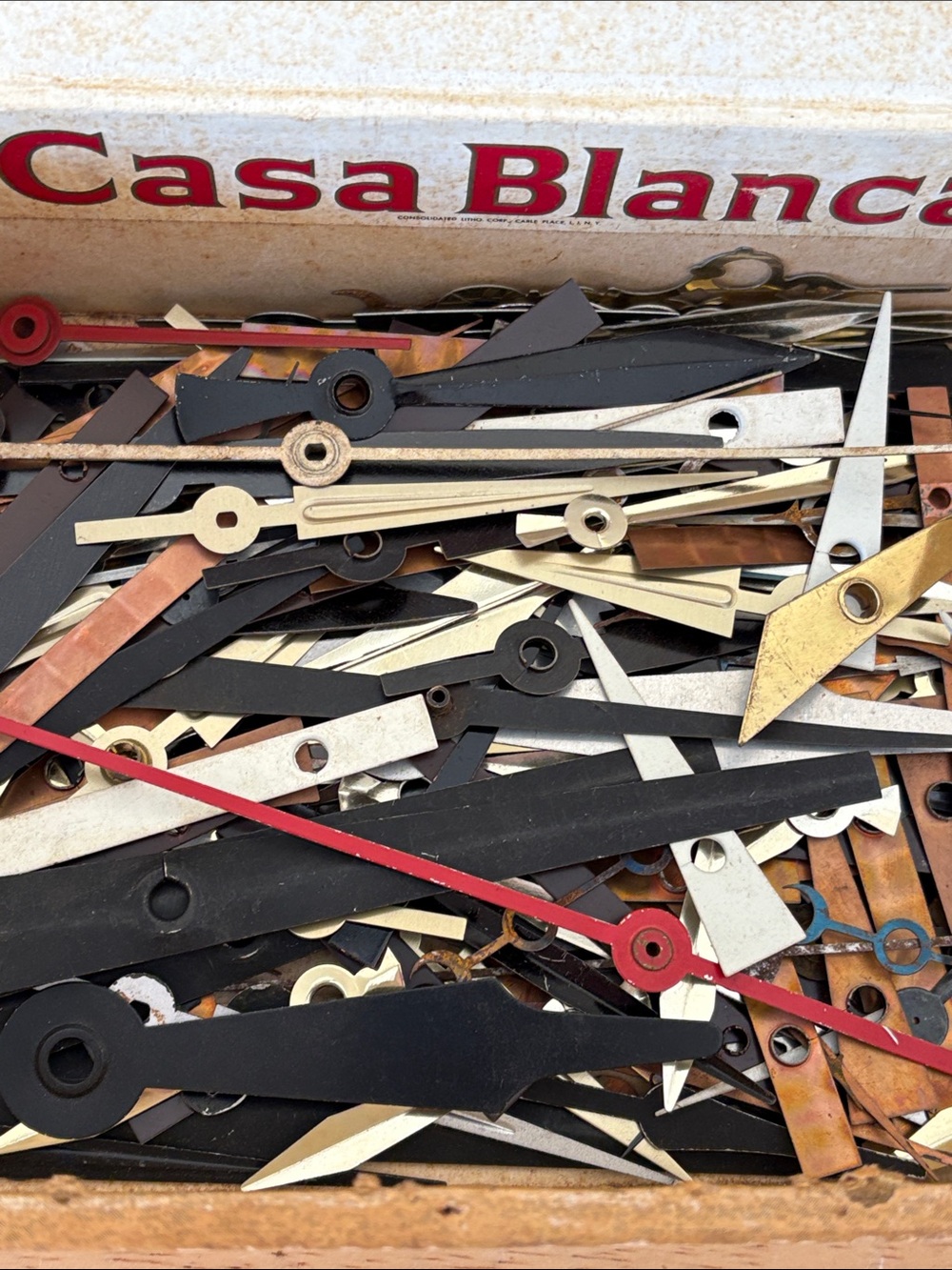 Old cigar box of clock hands